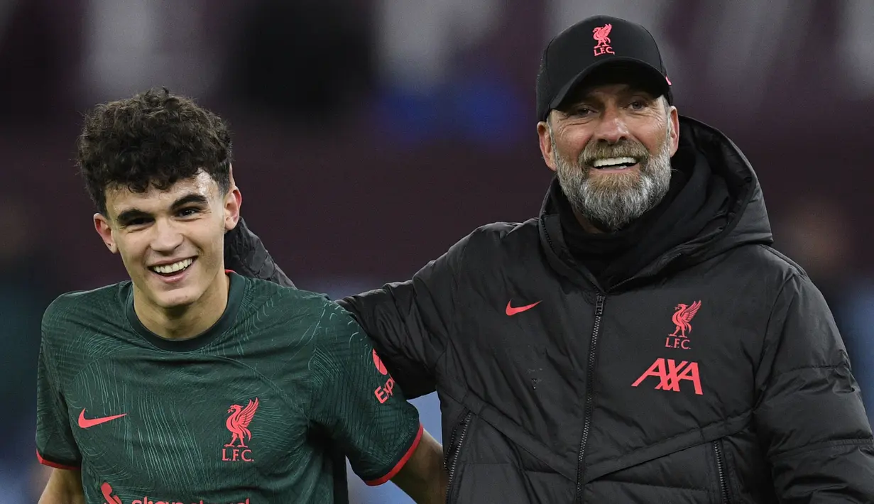 Bek Liverpool, Stefan Bajcetic bersama pelatih Jurgen Klopp merayakan kemenangan atas Aston Villa dalam laga Liga Inggris 2022/2023 di Villa Park, Birmingham (26/12/2022). Jika diturunkan dari awal laga saat melawan Real Madrid, bagi Stefan Bajcetic ini merupakan debutnya sebagai starter Liverpool di pentas Eropa. Sebelumnya ia telah tiga kali tampil bersama The Reds di Liga Champions musim 2022/2023 ini, namun semuanya berstatus pemain pengganti. (AFP/Oli Scarff)