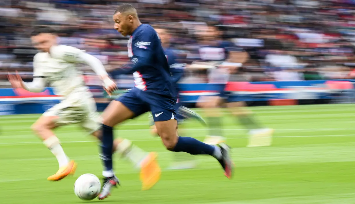 Pemain Paris Saint-Germain, Kylian Mbappe menggiring bola untuk melewati pemain FC Lorient pada laga lanjutan Liga Prancis 2022/2023 di The Parc des Princes Stadium, Paris, Prancis. 30 April 2023. (AFP/Franck Fife)