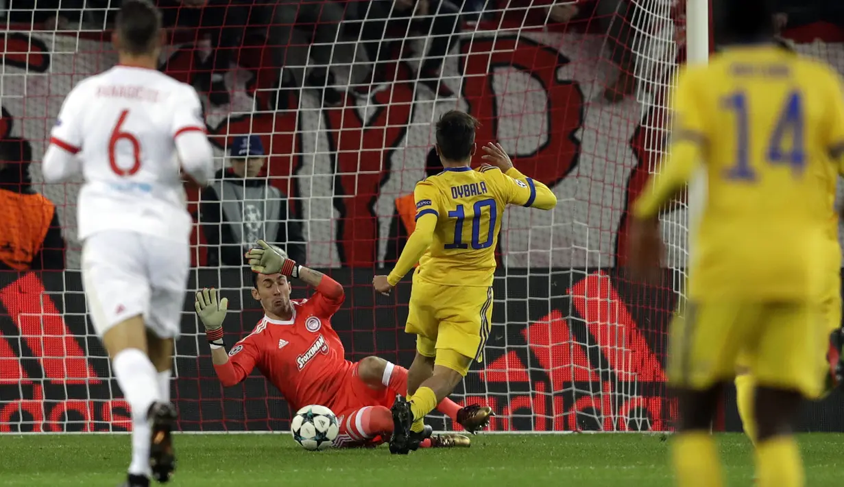 Kiper Olympiakos, Silvio Proto, berusaha menghadang tendangan striker Juventus, Paulo Dybala, pada laga Liga Champions di Stadion Georgios Karaiskakis, Rabu (6/12/2017). Juventus menang 2-0 atas Olympiakos. (AP/Thanassis Stavrakis)