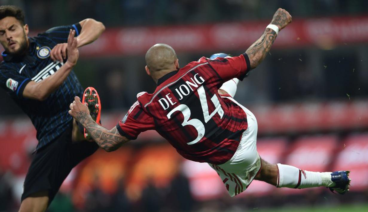 Pemain AC Milan Nigel de Jong melakukan tendangan akrobatik sambil dihadang pemain Inter Milan dalam Derby Della Madonnina Semalam, Senin (20/04/2015). Sumber : AFP