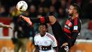 Gelandang Leverkusen, Karim Bellarabi, berusaha melewati bek sayap Bayern Munchen, David Alaba. Meski imbang, hasil ini tidak menggoyahkan Munchen di puncak klasemen Bundesliga. (AFP/Patrik Stollarz)