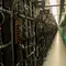 Rig pertambangan dari komputer super (kiri) dan filter udara yang berada dalam pabrik bitcoin 'Genesis Farming' di dekat Reykjavik, Islandia (16/3). (AFP Photo/Halldor Kolbeins)