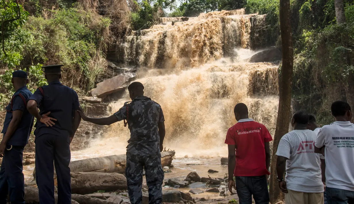 Petugas berada di lokasi air terjun Kintampo, Ghana (21/3). Air terjun ini merupakan lokasi wisata populer bagi warga Ghana, terutama para pelajar untuk menghabiskan waktu akhir pekan. (AFP Photo / Cristina Aldehuela)