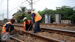Pekerja memperbaiki kondisi rel yang ada di dekat longsoran tanah di Citayam, Bogor, Rabu (25/11/2015). Sebelumnya, Selasa (24/11) tanah di sekitar rel KM 38 dan 39 mengalami longsor. (Liputan6.com/Helmi Fithriansyah)