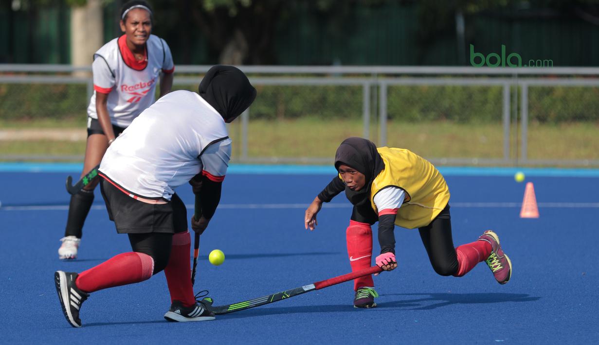 Duel timnas Hoki Putri Indonesia saat berlatih di Lapangan Hoki, Senayan, Jakarta, Selasa (2/4/2018). Tim Hoki terus melakukan adaptasi lapangan jelang Asian Games 2018. (Bola.com/Nick Hanoatubun)