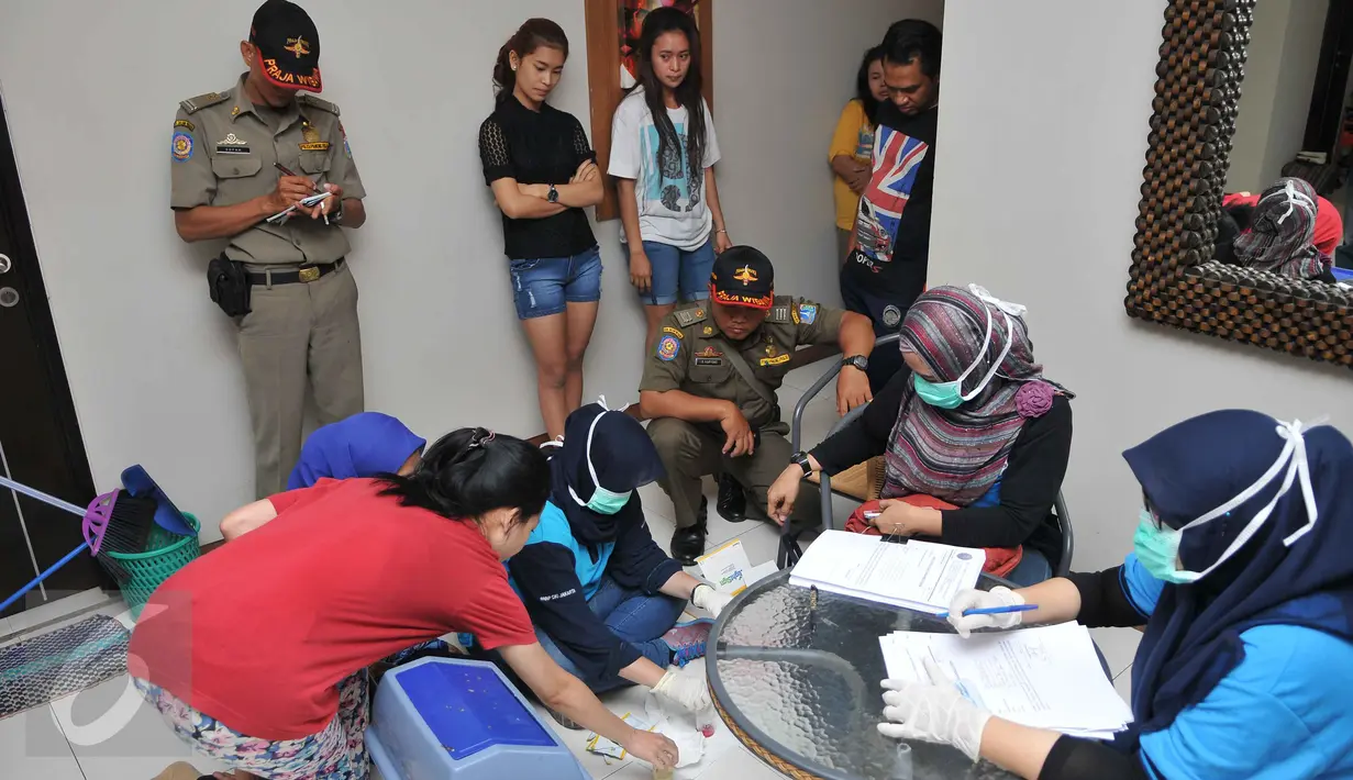Petugas BNN melakukan pendataan penghuni kos-kosan di Jalan Taman Sari Raya No 60-62, Jakarta (1/10/15). Dari razia ini, delapan orang terdiri dari tujuh wanita dan satu pria diamankan karena positif mengonsumsi narkoba. (Liputan6.com/Gempur M Surya)