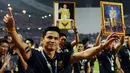 Pelatih Timnas Thailand, Kaitisuk Senamuang mengangkat tangan saat merayakan kemenangan atas Indonesia di National Stadium Rajamangala, Bangkok, Sabtu (17/12). Thailand berhasil meraih piala AFF untuk yang kelima kali. (Liputan6.com/Helmi Fithriansyah)