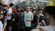Warga berfoto dengan para peserta parade seni budaya Kepulauan Nias saat Car Free Day di Kawasan Jalan Sudirman, Jakarta, Minggu (4/3). (Liputan6.com/Faizal Fanani)