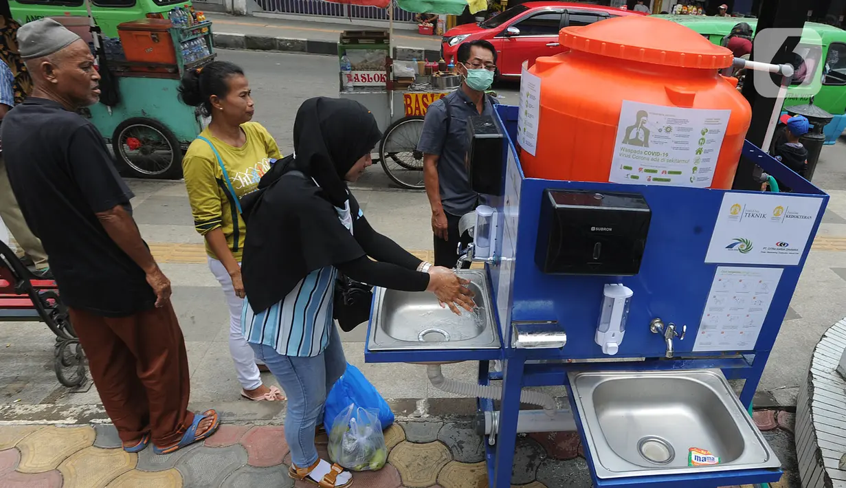 Warga menggunakan fasilitas tempat cuci tangan atau wastafel portabel di Pasar Bogor, Jalan Suryakencana, Kota Bogor, Sabtu (29/3/2020). Pemerintah Kota Bogor menerima bantuan berupa tempat cuci tangan portable dari Ikatan Alumni Teknik dan Alumni Ekonomi UI. (merdeka.com/Arie Basuki)
