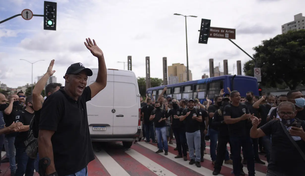 Polisi dan agen pasukan keamanan negara bagian Minas Gerais memblokir jalan saat menuntut kenaikan gaji di Brasil, 21 Februari 2022. Demonstrasi mendapat dukungan dari Komandan Umum Polisi Militer negara bagian dan mengumpulkan ribuan polisi serta agen keamanan publik. (Douglas MAGNO/AFP)