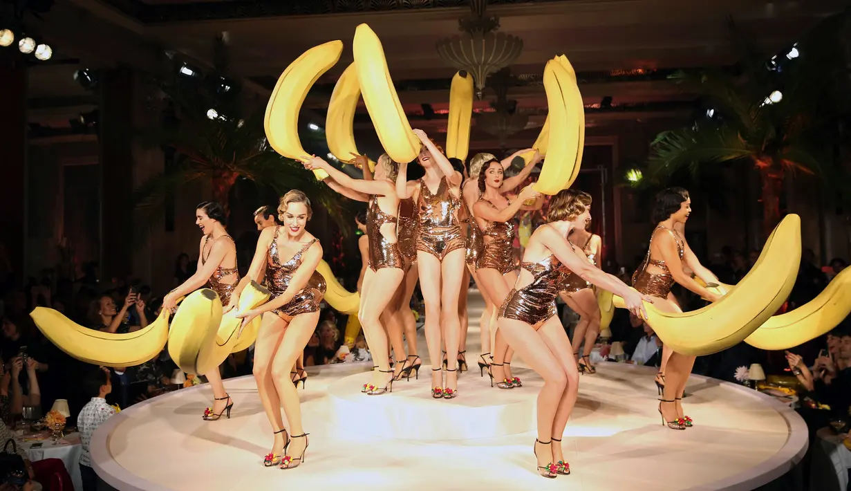 Pose para model dengan buah pisang  saat memperagakan busana karya Charlotte Olympia dalam Fashion Week Spring/Summer 2017 di London, Inggris, (18/9). (REUTERS/Neil Hall)