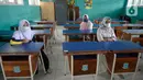 Wali murid berjaga jarak saat pembagian raport secara bergilir di SMP Negeri 18 Tangerang Selatan, Banten, Kamis (17/12/2020). Sebagai bentuk pencegahan penyebaran COVID-19, pihak sekolah menerapkan protokol kesehatan yang ketat saat pembagian raport. (merdeka.com/Dwi Narwoko)