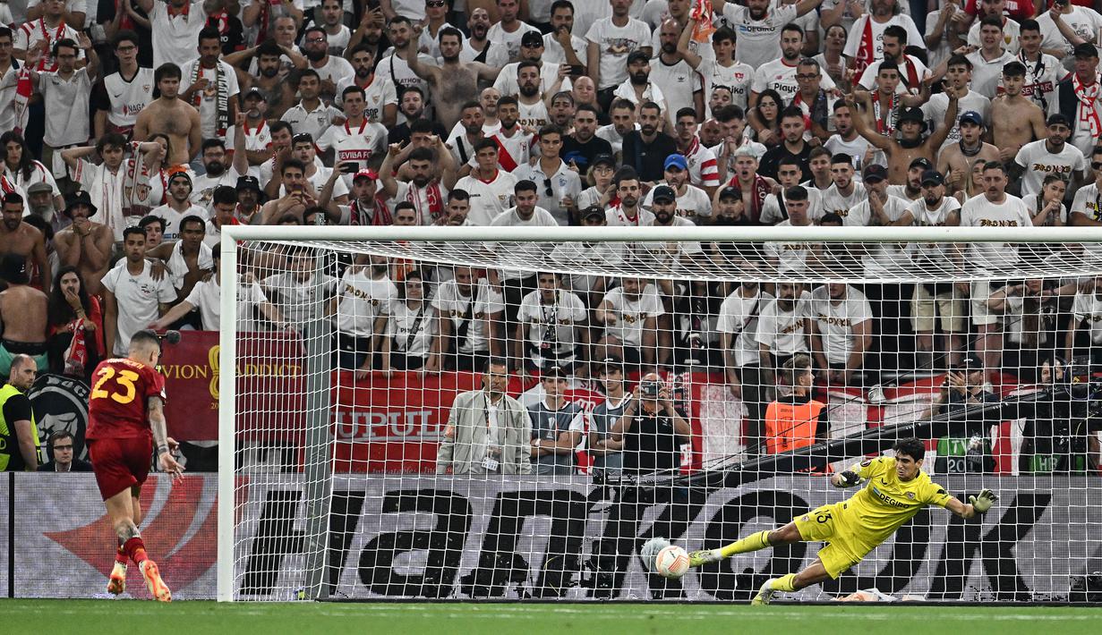 Kiper Sevilla, Yassine Bounou (kanan), berhasil menggagalkan tendangan penalti pemain AS Roma, Gianluca Mancini, dalam babak adu penalti final Liga Europa 2022/2023 yang berlangsung di Stadion Puskas Arena, Hungaria, Jumat (01/06/2023) dini hari WIB. (AFP/Joe Klamar)