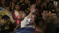 Presiden Jokowi menyapa warga saat meninggalkan lokasi pengungsian di Gor Sweca Pura, Klungkung, Bali, Salasa (26/9). Dalam kunjungannya Jokowi memberikan bantuan sebesar 7,1 Miliar. (Liputan6.com/Gempur M Surya)