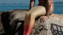 Davi de Oliveira Moreira berpose di Pantai Ipanema di Rio de Janeiro, Brasil, Rabu (3/5). Davi menjadi salah satu bagian dari penggila putri duyung yang sedang tumbuh di Brasil. ( AFP FOTO / YASUYOSHI CHIBA)