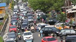 Sejumlah kendaraan melintasi Jalan Pramuka, Jakarta, Jumat (20/11). Banyaknya kendaraan pribadi yang parkir di kawasan tersebut menjadi salah satu penyebab kemacetan. terutama saat pagi hingga siang hari. (Liputan6.com/Immanuel Antonius)