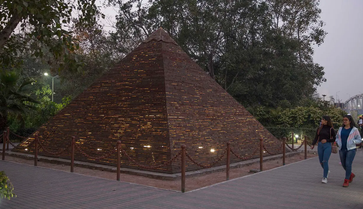 Pengunjung memandang replika Piramida Agung Giza di sebuah taman umum di New Delhi, 4 Februari 2020. Barang-barang bekas seperti besi batangan, suku cadang mobil, dan pipa dimanfaatkan untuk membuat tujuh keajaiban dunia yang ikonis di taman umum itu dan menarik banyak pengunjung. (Xinhua/Javed Dar)