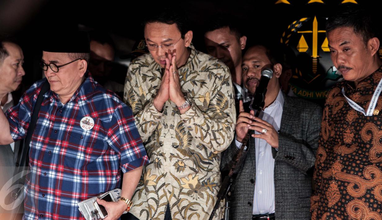 Tersangka dugaan penistaan agama, Basuki Tjahaja Purnama (Ahok) bersiap meninggalkan Gedung Kejagung, Jakarta, Kamis (1/12). Ahok keluar setelah satu jam menjalani proses penyerahan berkas, barang bukti dan tersangka. (Liputan6.com/Gempur M Surya)