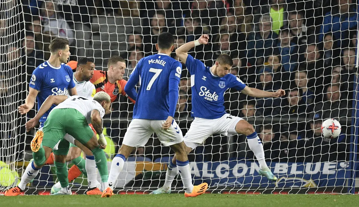 Pemain Newcastle United, Joelinton (kiri) mencetak gol kedua timnya ke gawang Everton pada laga pekan ke-33 Liga Inggris 2022/2023 di Goodison Park, Liverpool, Jumat (28/04/2023) dini hari WIB. The Magpies sukses menghajar tuan rumah dengan skor 4-1. (AFP/Oli Scarff)