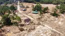 Bencana ini menyebabkan kerusakan parah dan menimbulkan banyak korban jiwa. Tampak dalam foto, warga berjalan di sepanjang jalan melewati desa yang terdampak banjir bandang di Batang Toru, Sumatera Utara, Senin 1 Desember 2025. (AP Photo/Binsar Bakkara)