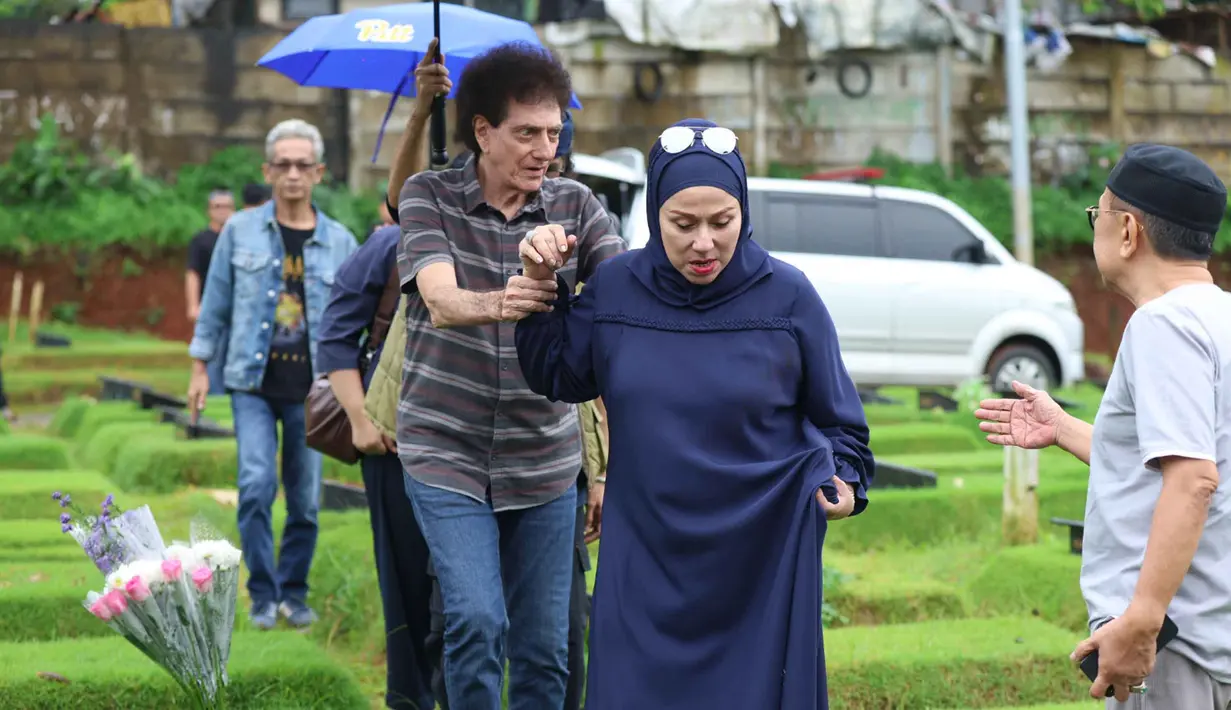 Suasana haru menyelimuti prosesi pemakaman Donny Fattah di Tempat Pemakaman Umum (TPU) Kampung Kandang, Jagakarsa, Sabtu (7/3/2026) sore. Tampak dalam foto, ekspresi vokalis grup band God Bless, Ahmad Albar (tengah) bersama Ian Antono (kanan) menyaksikan prosesi pemakaman jenazah Donny Fattah di Tempat Pemakaman Umum (TPU) Kampung Kandang, Jagakarsa, Jakarta Selatan, Sabtu (7/3/2026). (Kapanlagi.com/Budy Santoso)