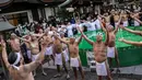 Penganut Shinto melakukan pemanasan sebelum mandi dengan air dingin di Kuil Teppozu Inari, Tokyo, Jepang, 8 Januari 2023. Ritual Tahun Baru ini dilakukan untuk memurnikan jiwa dan raga. (Philip FONG/AFP)