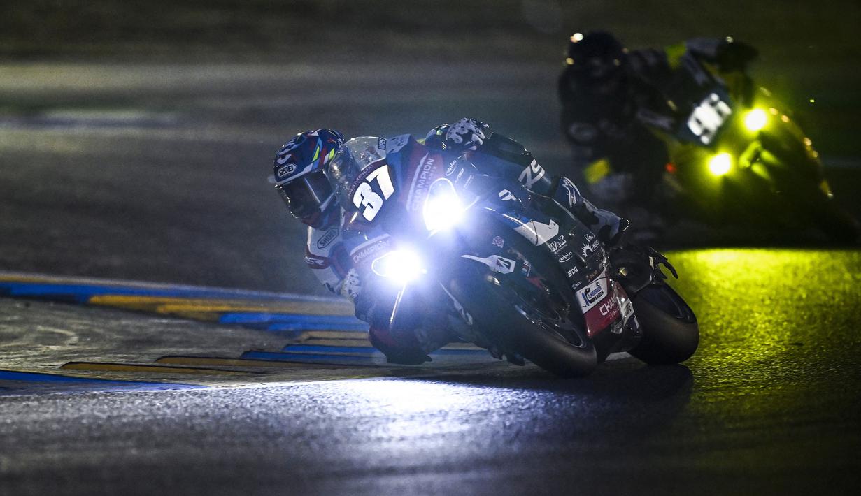 Pembalap Kawasaki Webike Trickstar, Roman Ramos Alvaro (kiri) dan pembalap Yoshimura Sert Motul, Etienne Masson berkompetisi dalam ajang 24 Hours of Le Mans yang berlangsung di Sirkuit Bugatti, Prancis, 19 April 2026 waktu setempat. (AFP/Julien De Rosa)