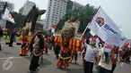 Massa aksi Hari Buruh Internasional membawa reog saat long march dari Tugu Tani ke depan Istana Merdeka hingga ke Monas, Jakarta, Senin (1/5) Dalam aksinya para buruh meminta sistem kerja kontrak dan upah rendah dihapus. (Liputan6.com/Helmi Afandi)
