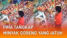 Pria itu dengan sigap menangkap minyak goreng kemasan tersebut.