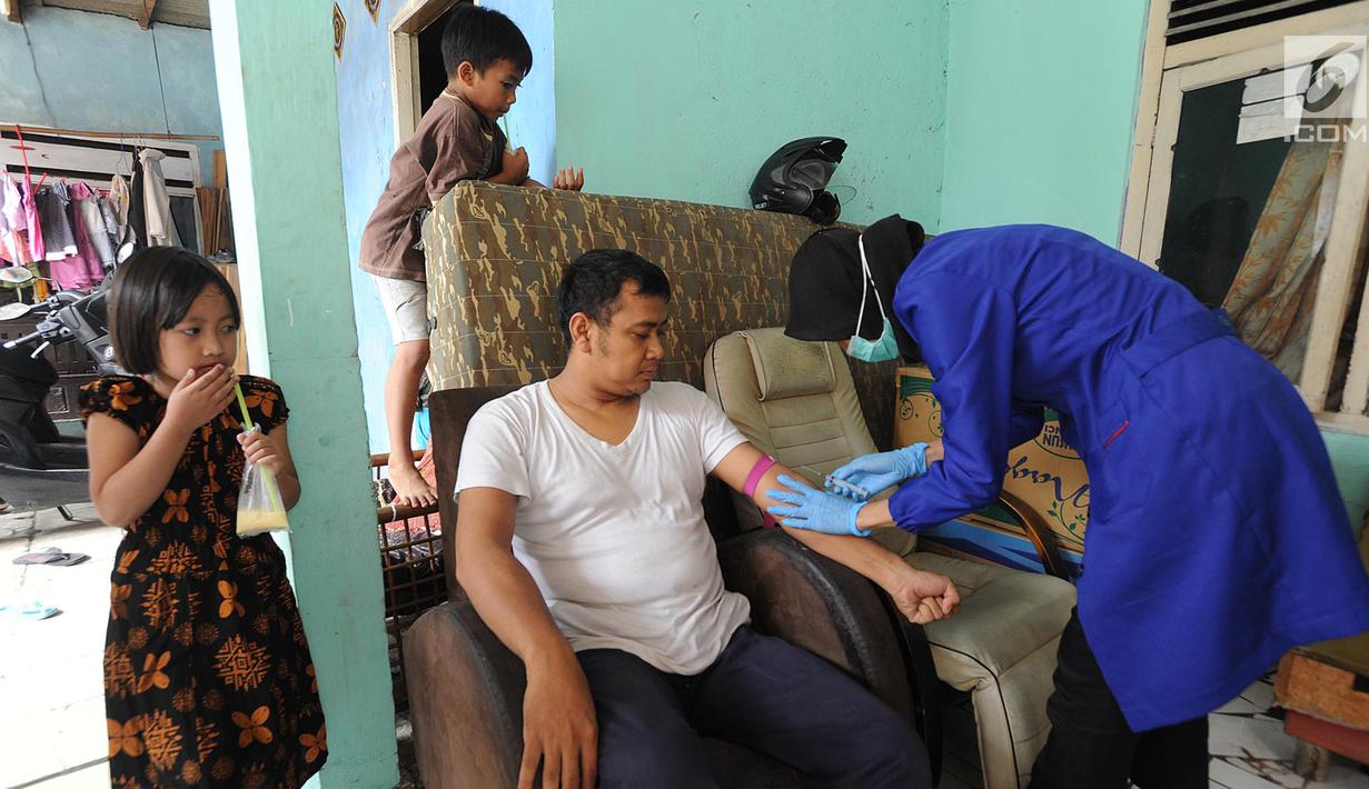 Petugas melakukan pengambilan sample darah warga di Cinere, Depok, Rabu (28/6/2019). Dinas Kesehatan Depok dan Puskesmas Cinere melakukan investigasi sumber penyakit dan sampel darah warga di kawasan ini terkait sudah lebih dari sepekan 12 warga terjangkit hepatitis A. (merdeka.com/Arie Basuki)