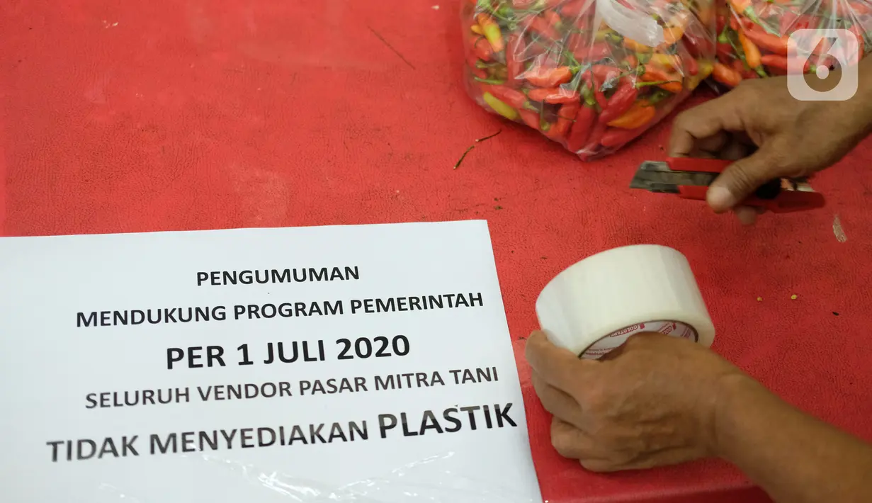 Petugas bersiap menempel pengumuman terkait penggunaan kantong plastik di Pasar Mitra Tani, Jakarta, Selasa (30/6/2020). Pasar Mitra Tani akan melarang penggunaan kantong plastik sekali pakai untuk seluruh vendor dan konsumen pasar mulai Rabu, 1 Juli 2020. (Liputan6.com/Angga Yuniar)