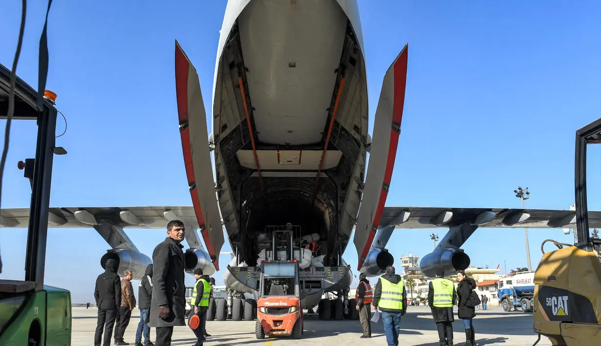 Paket bantuan kemanusiaan yang disediakan oleh Arab Saudi untuk para korban gempa bumi Turki dan Suriah diturunkan dari pesawat angkut Ilyushin Il-76TD di Bandara Internasional Aleppo, Suriah Utara, Selasa (14/2/2023). Proses pencarian dan evakuasi korban hingga kini masih berlangsung. Pada Senin (13/2) tercatat ada 37.357 orang tewas di Turki dan Suriah akibat gempa berkekuatan magnitudo 7,8 tersebut. (AFP)