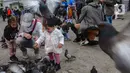 Wisatawan berkumpul sambil memberi makan dan bermain dengan burung merpati di Dam Square, Amsterdam, Belanda, Sabtu (26/5/2024). (merdeka.com/Arie Basuki)