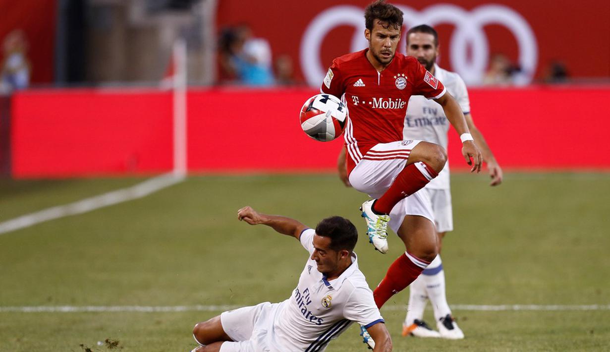 Pemain Real Madrid, Lucas Vasquez, berebut bola dengan pemain Bayern Munchen, Juan Bernat (kanan), pada laga lanjutan International Champions Cup 2016 di MetLife Stadium, New Jersey, AS, Kamis (4/8/2016) pagi WIB. (AFP/Jeff Zelevansky/Getty Images)