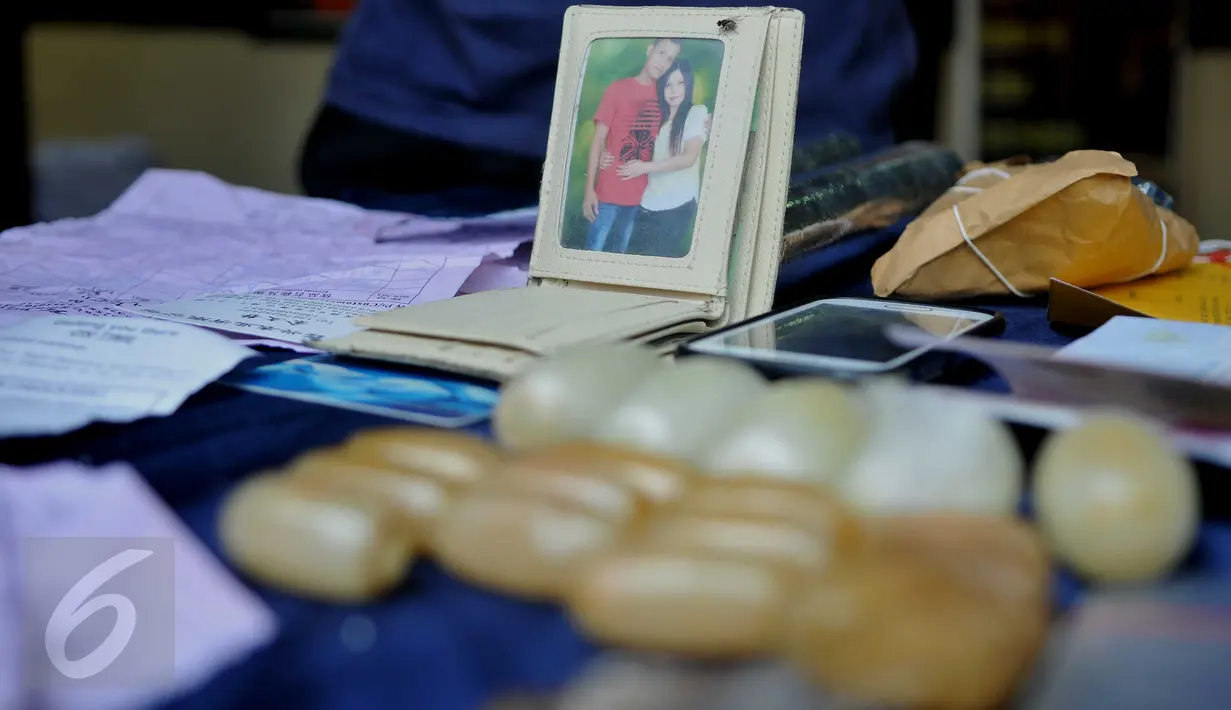 Barang bukti dan dompet tersangka penyelundupan Narkoba Jenis Kristal Shabu berinisial INN, Polsek Penjaringan, Jakarta, (28/3). Pria ini ditangkap setelah menyelundupkan narkoba jenis shabu yang dikemas dalam 17 kapsul. (Liputan6.com/Gempur M Surya)