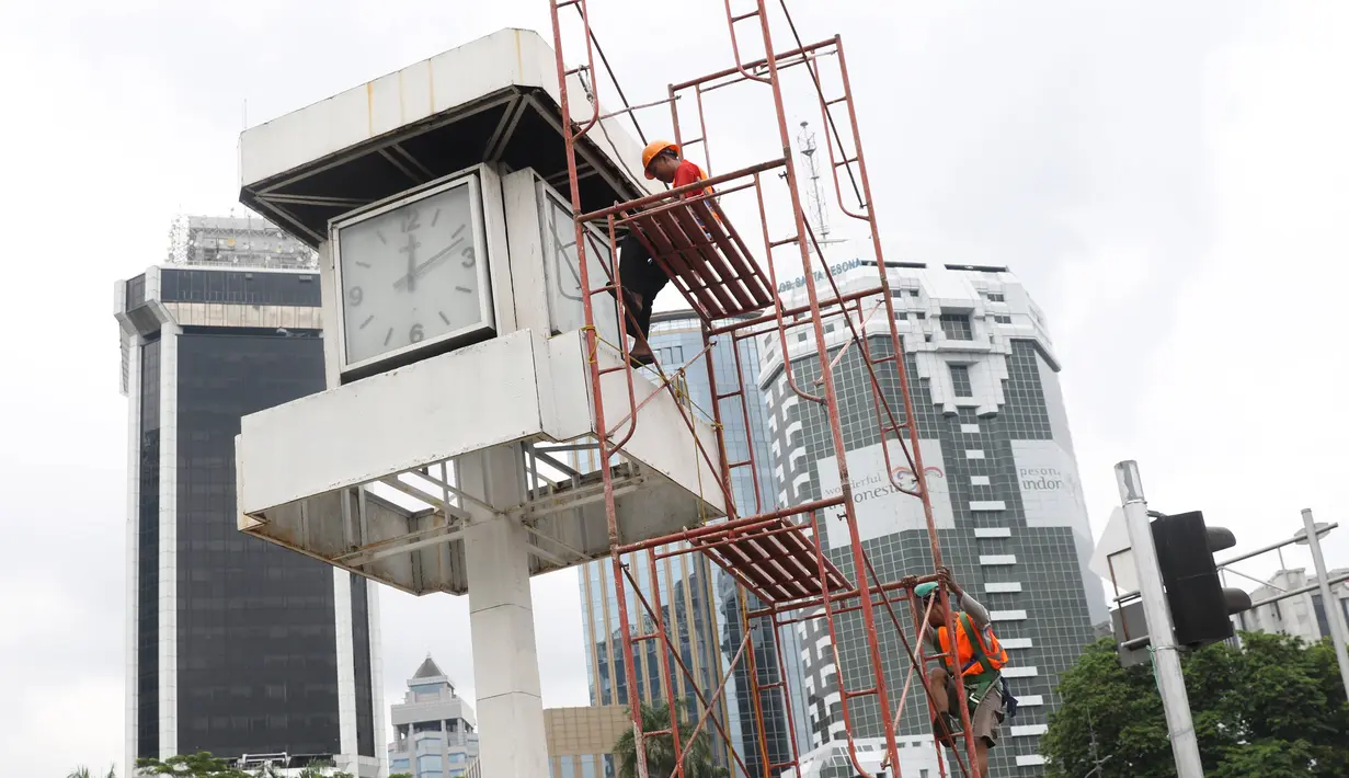 Petugas melakukan perawatan tugu jam yang berada di Merdeka Selatan, Jakarta, Minggu (2/2/2020). Perawatan tersebut dilakukan untuk pengecekan kondisi jam yang nantinya akan dipasangkan panel surya sebagai daya power agar tugu jam dapat berfungsi sebagai petunjuk waktu. (Liputan6.com/Angga Yuniar)