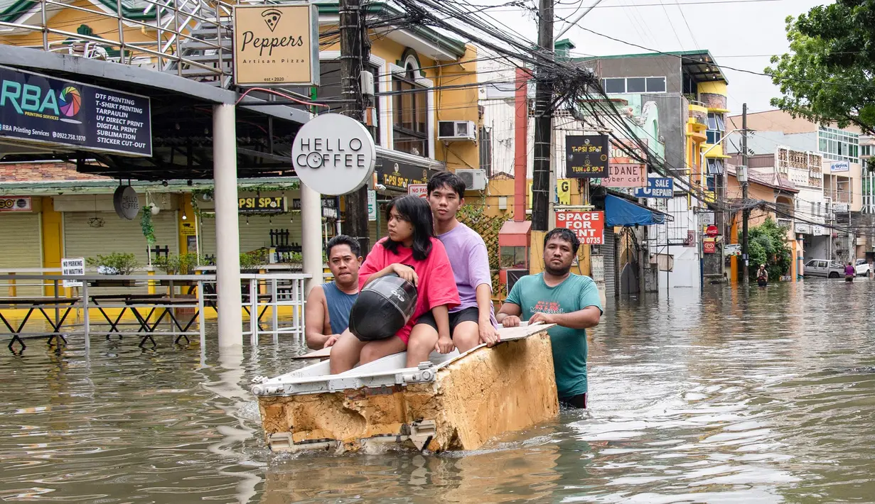 Hujan deras yang menyebabkan banjir kali ini merupakan bagian dari hujan monsun yang terus berlangsung di berbagai wilayah Filipina sejak Badai Tropis Wipha menerjang sejak Jumat 18 Juli 2025 lalu. (Ted ALJIBE/AFP)