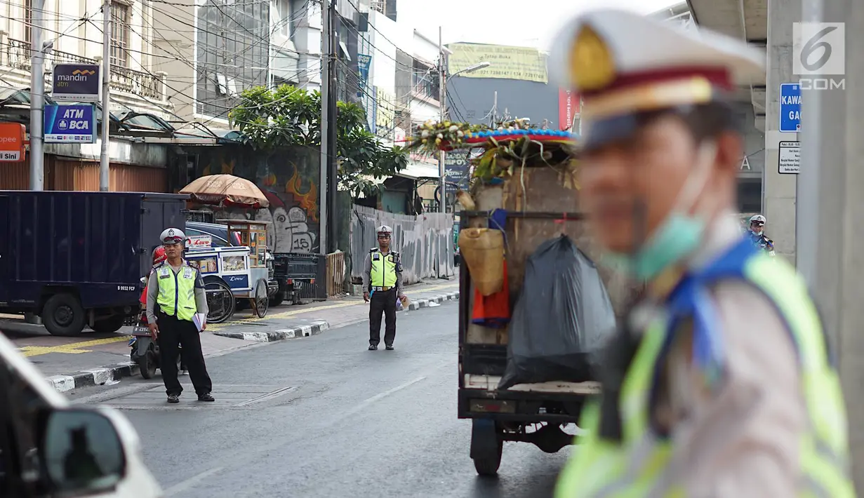 Petugas Kepolisian berjaga di persimpangan Jalan Dharmawangsa X dan Jalan Fatmawati, Jakarta, Senin (9/9/2019). Polisi mulai menindak pengendara yang melanggar perluasan ganjil genap di Jakarta Selatan. (Liputan6.com/Immanuel Antonius)