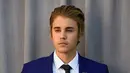 Memiliki tato baru di tubuhnya, nampaknya Justin Bieber sangatlah senang. Seperti yang diketahui bahwa ia sangat gemar menggambarkan tubuhnya dengan tato, terlebih ia selalu menambahnya selama lima tahun ini. (AFP/Frazer Harrison)