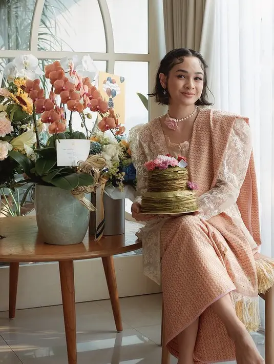 Andien Aisyah juga tampil bernuansa pastel dengan kebaya putih dipadukan selendang dan kain bawahan motif dan warna yang sama. [@andienaisyah]