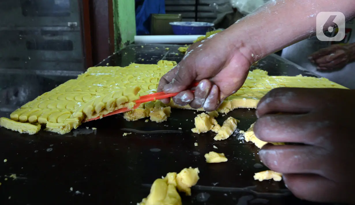 Pekerja mencetak adonan kue kering di usaha pembuatan kue Pusaka Kwitang di kawasan Kwitang, Jakarta Pusat, Selasa (27/4/2021). Kue kering yang diproduksi antara lain putri salju, kastengel, nastar, kue lidah kucing, dan kue kacang. (merdeka.com/Imam Buhori)