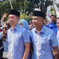 Ratusan pendukung mengiringi keberangkatan pasangan bakal calon wali kota-wakil wali kota Dedie Abdul Rachim dan Jenal Mutaqin untuk mendaftar ke KPU Kota Bogor. (Liputan6.com/Achmad Sudarno)