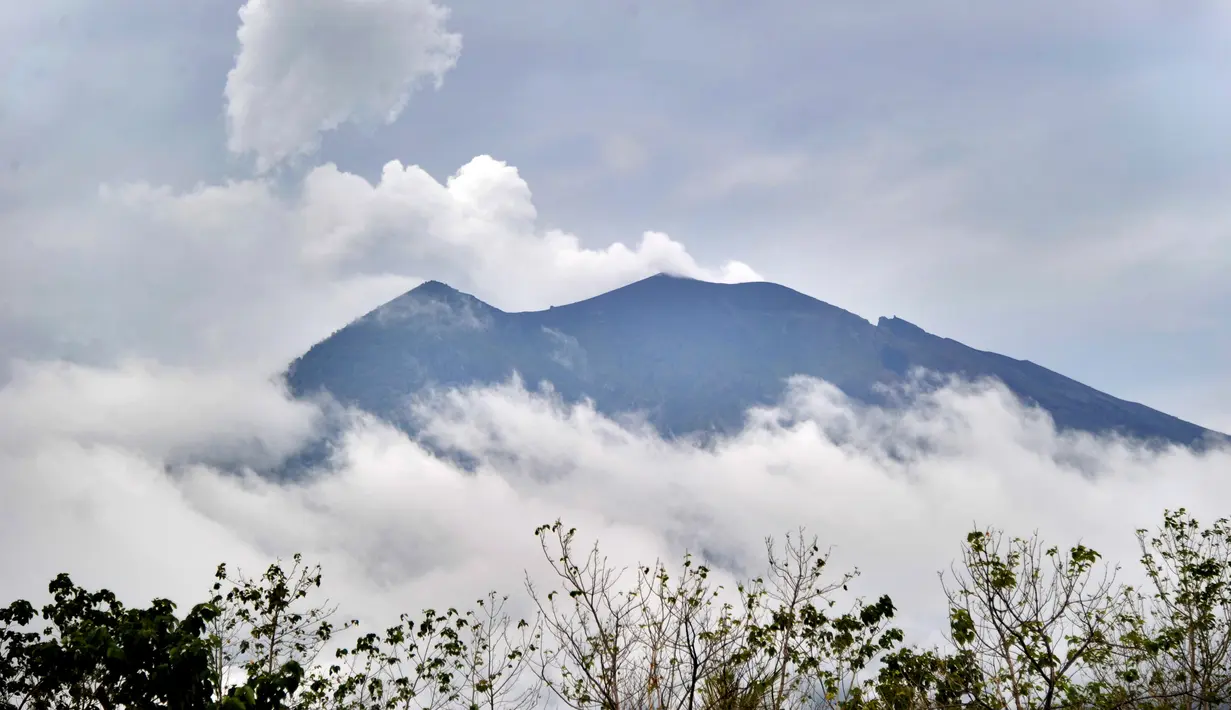 Pemandangan Gunung Agung terlihat dari kecamatan Kubu di Kabupaten Karangasem, Bali, Rabu (22/11). Pusat Vulkanologi dan Mitigasi Bencana Geologi merekomendasikan masyarakat untuk tidak berada pada radius hingga 7,5Km (SONNY TUMBELAKA/AFP)