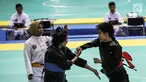 Pesilat Nirmalasari Oktaviani (kanan) beradu jurus dengan pesilat Laos Olathai Sounthavong di semifinal 50-55 kg putri cabang Pencak Silat 18th Asian Games Invitation Tournament, Jakarta, Senin (12/2). Indonesia menang 5-0. (Liputan6.com/Faizal Fanani)
