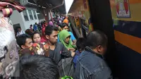 Pemudik memasuki kereta api di Stasiun Senen, Jakarta, Selasa (7/7/2015). Para pemudik mengaku sengaja mudik lebih awal untuk menghindari puncak arus mudik yang diperkirakan akan terjadi pada H-5 Lebaran. (Liputan6.com/Herman Zakharia)