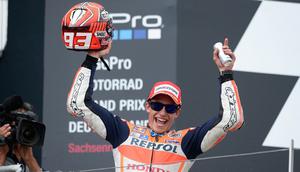 Pembalap Tim Repsol Honda Marc Marquez merayakan kemenangan pada gelaran MotoGP di Sirkuit Sachsenring, Jerman, Minggu (12/7/2015). Pembalap muda ini tak terbendung pada balapan kali ini. (AFP PHOTO/Robert Michael)