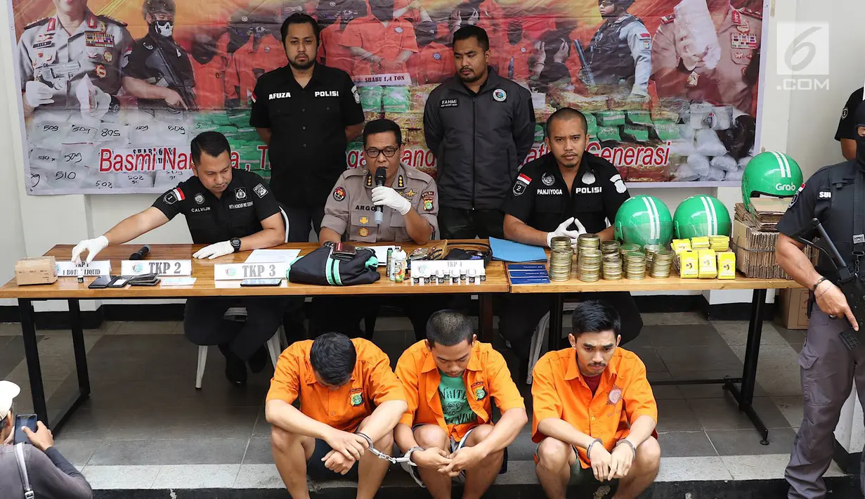 Kabid Humas Polda Metro Jaya Kombes Argo Yuwono (tengah) menunjukkan tersangka jual beli narkoba liquid vape di Jakarta, Kamis (25/10). Subdit I Ditresnarkoba Polda Metro Jaya menangkap tiga pria berinisial ER, AG, dan TM. (Liputan6.com/Immanuel Antonius)