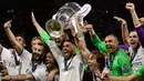 Kapten Real Madrid, Sergio Ramos mengangkat trofi bersama timnya usai memenangkan pertandingan Liga Champions di Stadion Cardiff, Wales (3/6). (AFP Photo/Javier Soriano)