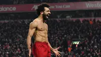 Gelandang Liverpool, Mohamed Salah, merayakan gol yang dicetaknya ke gawang Manchester United pada laga Premier League di Stadion Anfield, Liverpool, Minggu (19/1). Liverpool menang 2-0 atas MU. (AFP/Paul Ellis)