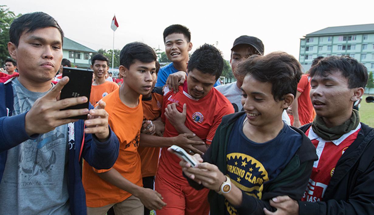 Sejumlah The Jakmania mendekati penyerang Persija Jakarta, Bambang Pamungkas usai mengikuti latihan bersama tim Macan Kemayoran jelang Piala Presiden 2015 di Lapangan Yon Zikon 14, Jakarta, Senin (24/8/2015). (Bola.com/Vitalis Yogi Trisna)